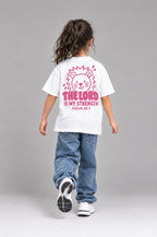 Kind trägt das weiße Kinder T-Shirt „The Lord is my strength“ von Little Faith